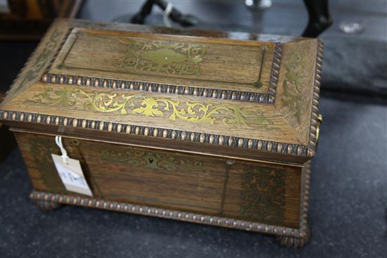 A Regency rosewood and brass inlaid sarcophagus shaped tea caddy, 13.75in.